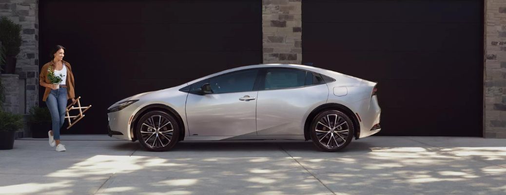 One grey color 2023 Toyota Prius is parked outside a building.