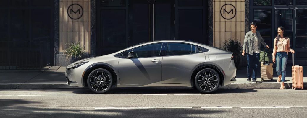 One grey color 2023 Toyota Prius is parked outside a building.