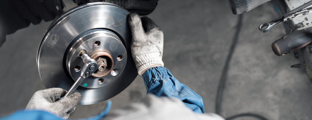 A mechanic repairing a vehicle's brakes