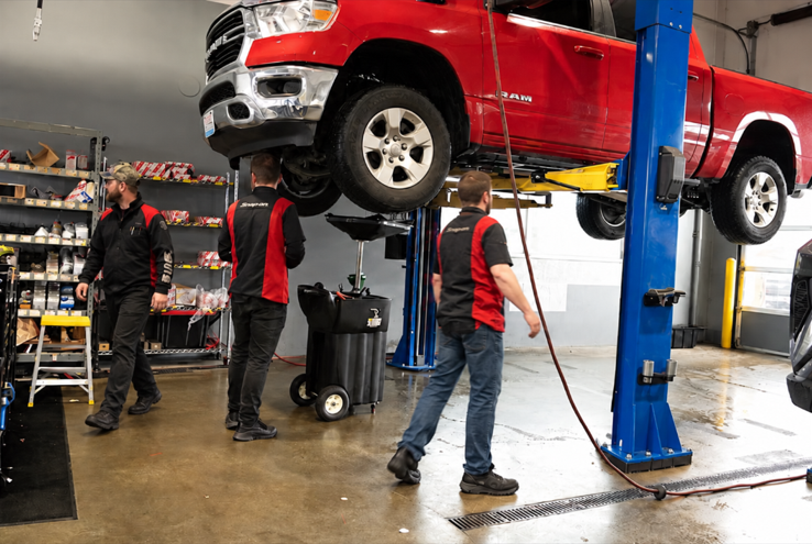 Ram truck raised on lift during service appointment