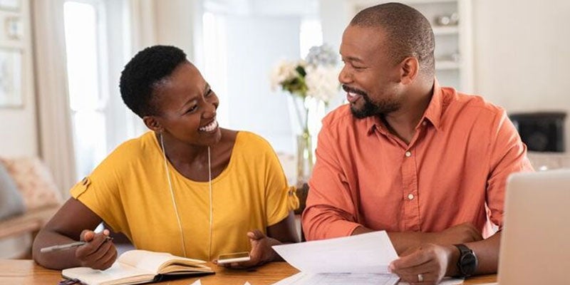 Smiling married couple managing a budget