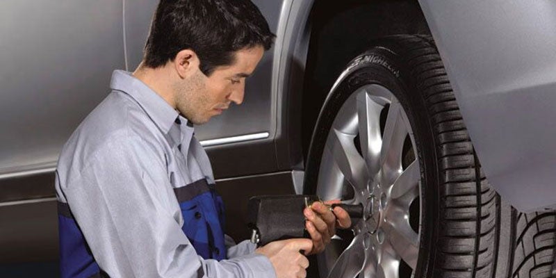 Service technician performing tire rotation