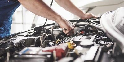 technician repairing exhaust